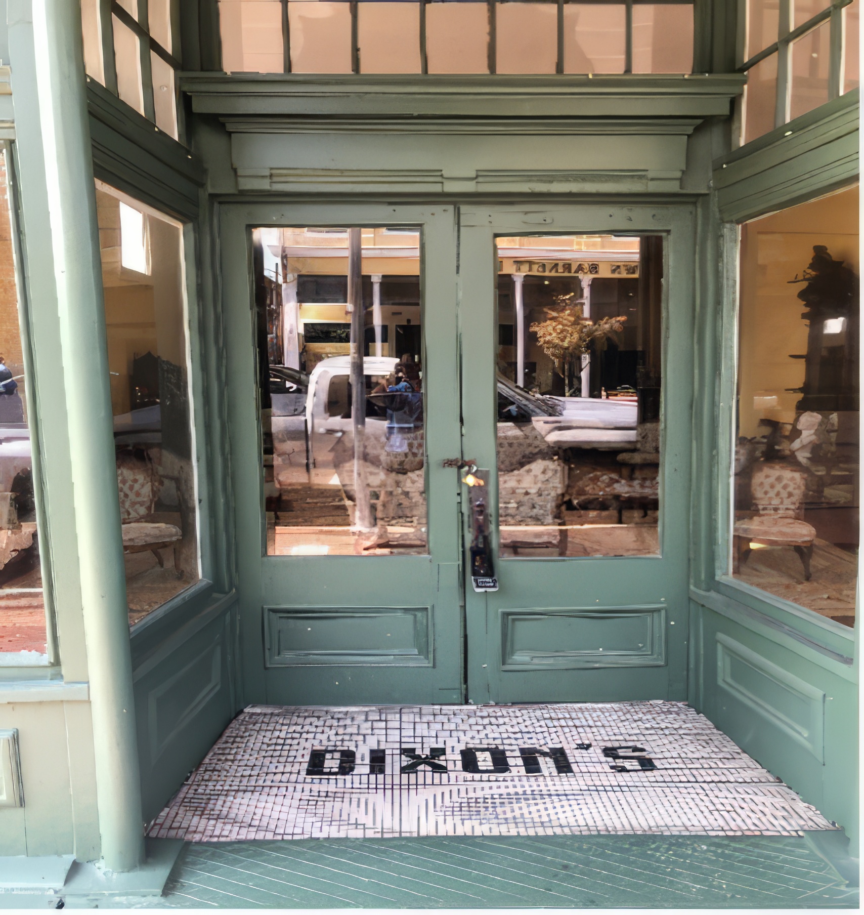 The Dixon building storefront and entryway with custom tile on the ground that spells Dixon's
